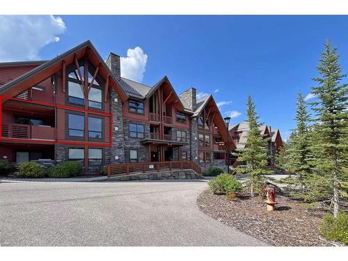 201-2100B Stewart Creek Drive, Canmore, AB - Outdoor With Balcony With Facade