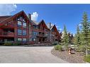 201-2100B Stewart Creek Drive, Canmore, AB  - Outdoor With Balcony With Facade 