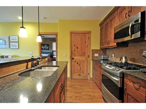 201-2100B Stewart Creek Drive, Canmore, AB - Indoor Photo Showing Kitchen With Double Sink