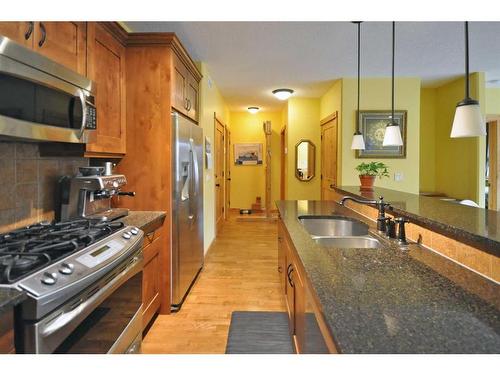 201-2100B Stewart Creek Drive, Canmore, AB - Indoor Photo Showing Kitchen With Double Sink