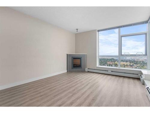 2207-99 Spruce Place Sw, Calgary, AB - Indoor Photo Showing Living Room With Fireplace