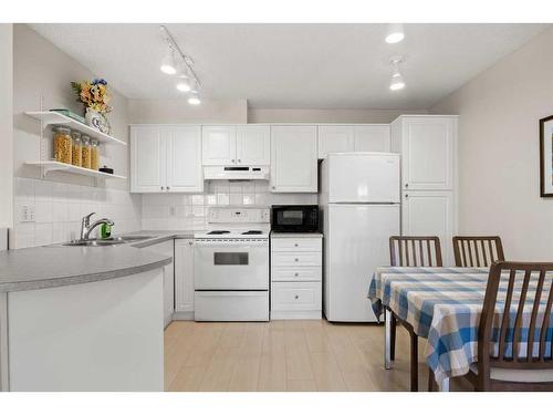 206-30 Sierra Morena Mews Sw, Calgary, AB - Indoor Photo Showing Kitchen With Double Sink