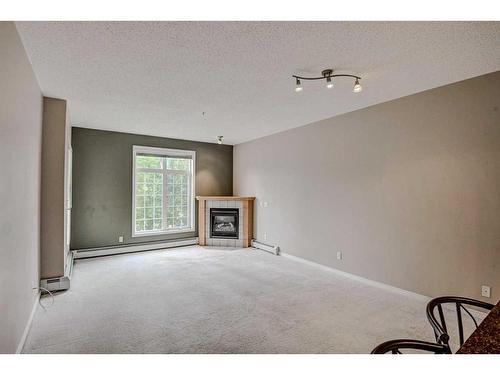 334-5201 Dalhousie Drive Nw, Calgary, AB - Indoor Photo Showing Other Room With Fireplace