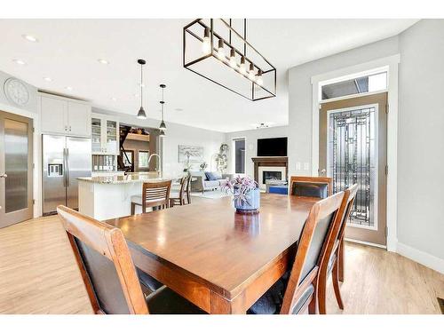 152 Drake Landing Terrace, Okotoks, AB - Indoor Photo Showing Dining Room With Fireplace