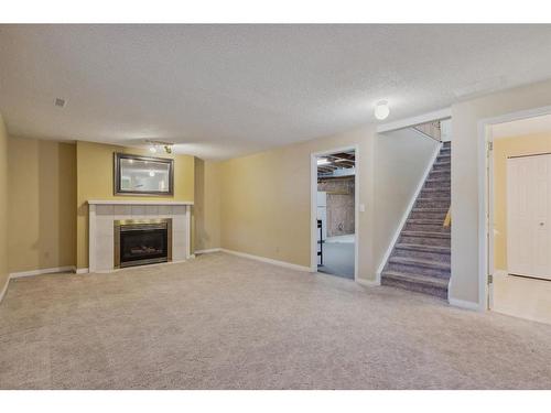 181 Macewan Ridge Villas, Calgary, AB - Indoor Photo Showing Living Room With Fireplace