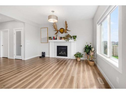 1328 Lackner Boulevard, Carstairs, AB - Indoor Photo Showing Living Room With Fireplace