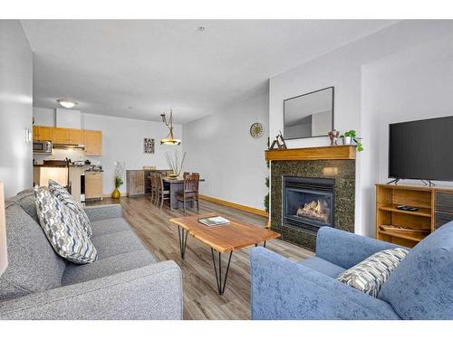 316-1151 Sidney Street, Canmore, AB - Indoor Photo Showing Living Room With Fireplace