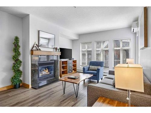 316-1151 Sidney Street, Canmore, AB - Indoor Photo Showing Living Room With Fireplace