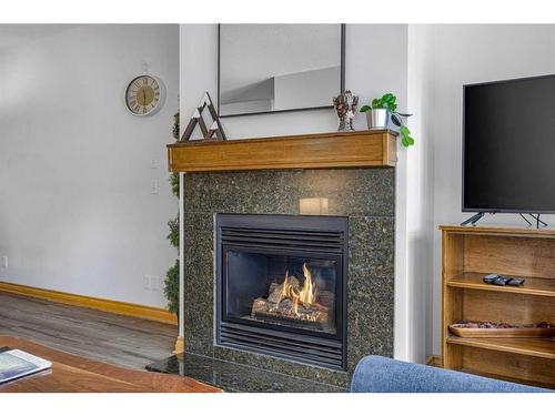 316-1151 Sidney Street, Canmore, AB - Indoor Photo Showing Living Room With Fireplace