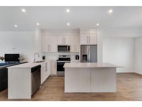 404-669 Savanna Boulevard Ne, Calgary, AB - Indoor Photo Showing Kitchen With Stainless Steel Kitchen With Double Sink With Upgraded Kitchen