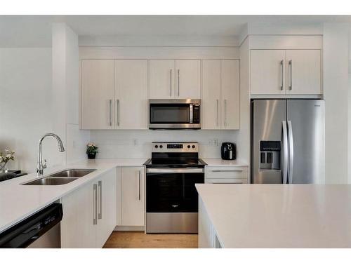 404-669 Savanna Boulevard Ne, Calgary, AB - Indoor Photo Showing Kitchen With Stainless Steel Kitchen With Double Sink With Upgraded Kitchen