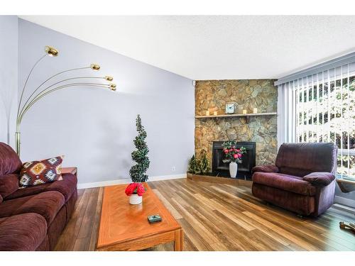 271 Deersaxon Circle Se, Calgary, AB - Indoor Photo Showing Living Room With Fireplace