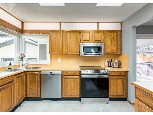 56 Glenwood Place, Cochrane, AB - Indoor Photo Showing Kitchen With Double Sink