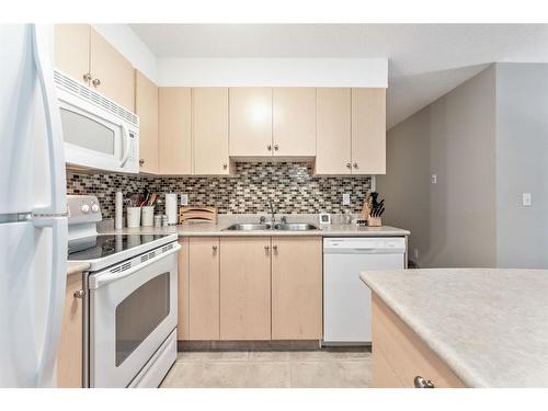 1125-2395 Eversyde Avenue Sw, Calgary, AB - Indoor Photo Showing Kitchen With Double Sink