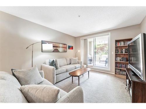 1125-2395 Eversyde Avenue Sw, Calgary, AB - Indoor Photo Showing Living Room