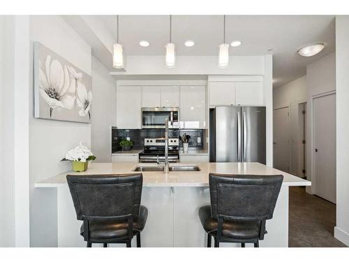 413-19621 40 Street Se, Calgary, AB - Indoor Photo Showing Kitchen With Stainless Steel Kitchen With Upgraded Kitchen