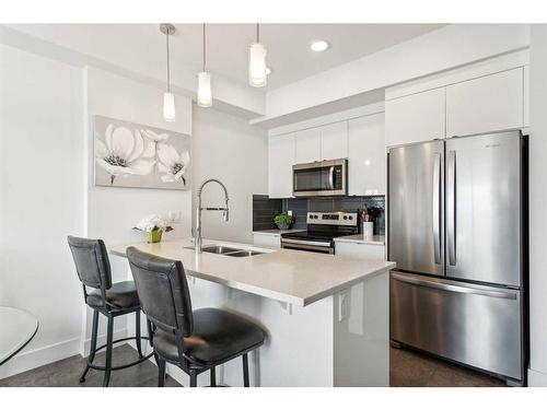 413-19621 40 Street Se, Calgary, AB - Indoor Photo Showing Kitchen With Stainless Steel Kitchen With Double Sink With Upgraded Kitchen