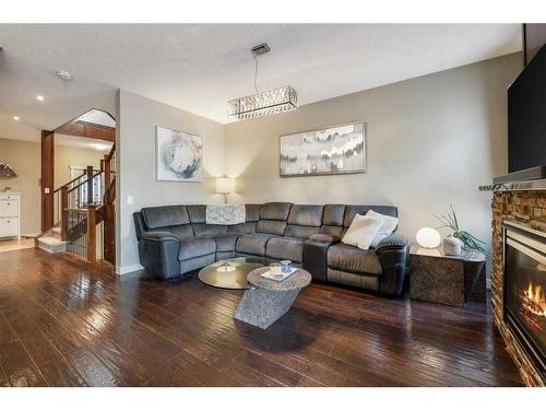 994 Shantz Place, Crossfield, AB - Indoor Photo Showing Living Room With Fireplace