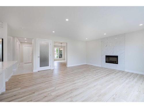 255 Panorama Hills Manor Nw, Calgary, AB - Indoor Photo Showing Living Room With Fireplace