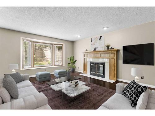 53 Shawnee Rise Sw, Calgary, AB - Indoor Photo Showing Living Room With Fireplace