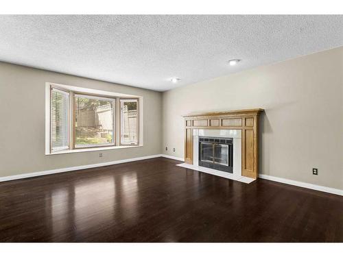 53 Shawnee Rise Sw, Calgary, AB - Indoor Photo Showing Living Room With Fireplace