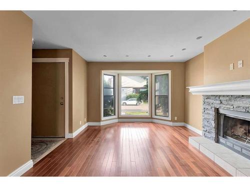 144 Macewan Glen Close Nw, Calgary, AB - Indoor Photo Showing Living Room With Fireplace