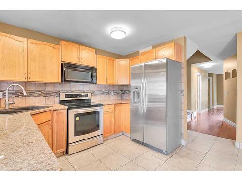 144 Macewan Glen Close Nw, Calgary, AB - Indoor Photo Showing Kitchen With Double Sink