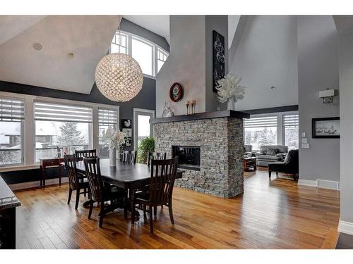 204 Leighton Court, Rural Rocky View County, AB - Indoor Photo Showing Dining Room With Fireplace