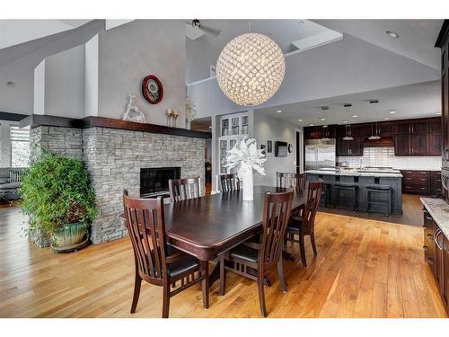 204 Leighton Court, Rural Rocky View County, AB - Indoor Photo Showing Dining Room With Fireplace