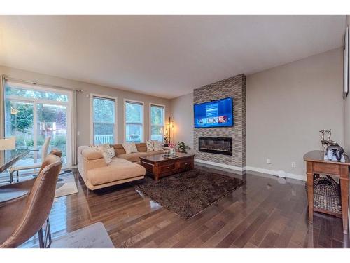 124 Westcreek Green, Chestermere, AB - Indoor Photo Showing Living Room With Fireplace