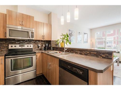 1220-10 Auburn Bay Avenue Se, Calgary, AB - Indoor Photo Showing Kitchen With Stainless Steel Kitchen With Double Sink