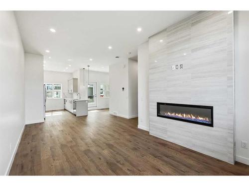 211-595 Mahogany Road Se, Calgary, AB - Indoor Photo Showing Living Room With Fireplace