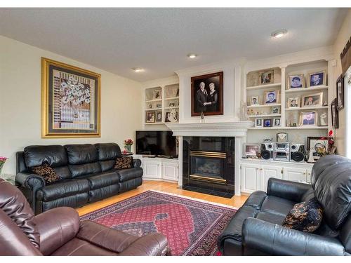 1625 Evergreen Drive Sw, Calgary, AB - Indoor Photo Showing Living Room With Fireplace