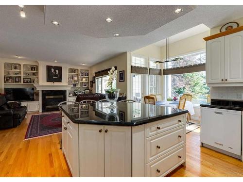 1625 Evergreen Drive Sw, Calgary, AB - Indoor Photo Showing Kitchen With Fireplace