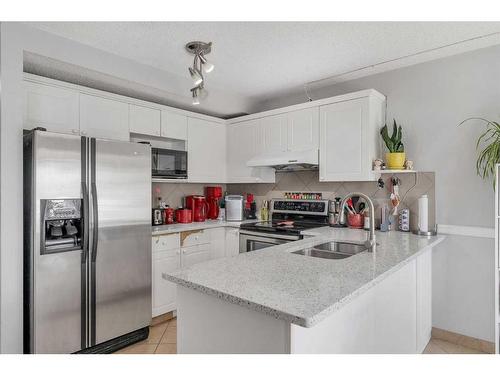 80 Saddlecreek Terrace Ne, Calgary, AB - Indoor Photo Showing Kitchen With Double Sink With Upgraded Kitchen