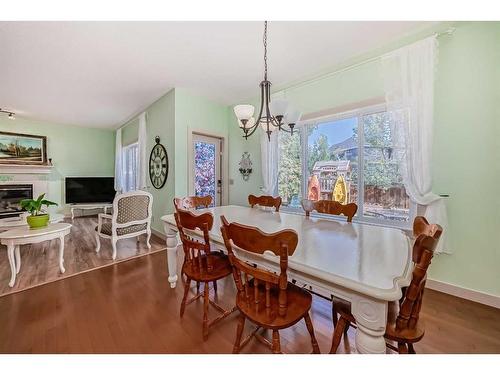 204 Silverado Boulevard Sw, Calgary, AB - Indoor Photo Showing Dining Room With Fireplace