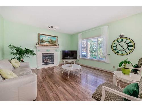 204 Silverado Boulevard Sw, Calgary, AB - Indoor Photo Showing Living Room With Fireplace