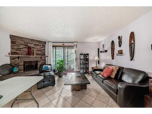 2109-4001B 49 Street Nw, Calgary, AB - Indoor Photo Showing Living Room With Fireplace