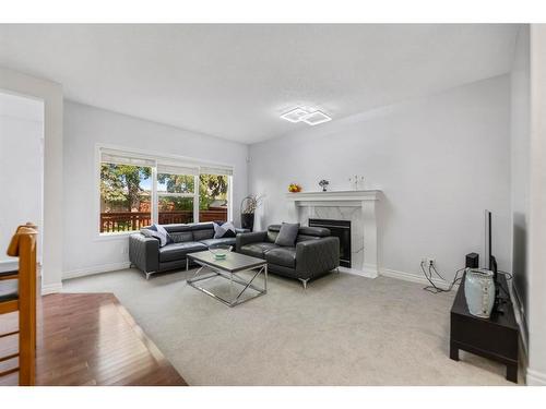 261 Bridleridge View Sw, Calgary, AB - Indoor Photo Showing Living Room With Fireplace