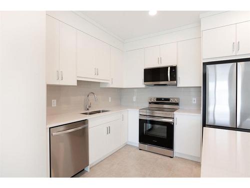 317-125 Wolf Hollow Crescent Se, Calgary, AB - Indoor Photo Showing Kitchen With Stainless Steel Kitchen