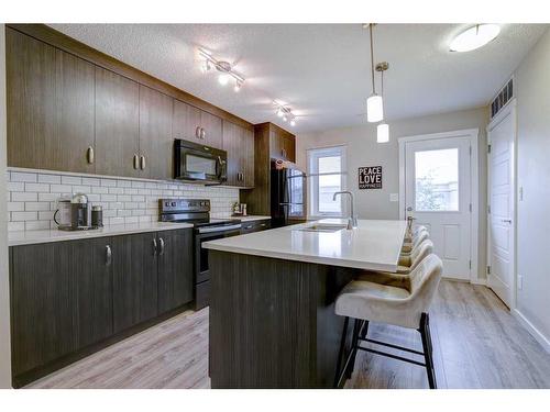 408-50 Westland Road, Okotoks, AB - Indoor Photo Showing Kitchen With Upgraded Kitchen