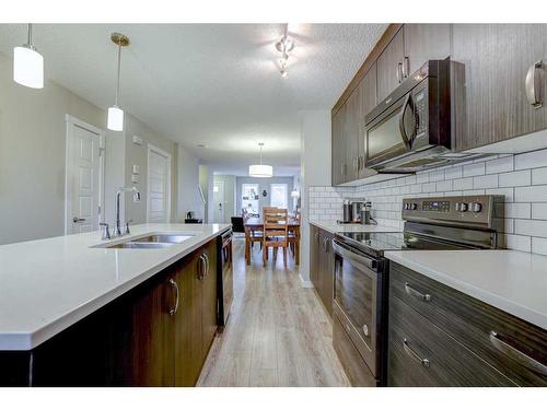 408-50 Westland Road, Okotoks, AB - Indoor Photo Showing Kitchen With Double Sink With Upgraded Kitchen