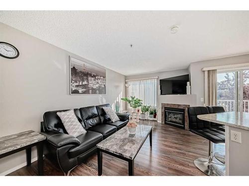 204-3204 Valleyview Park Se, Calgary, AB - Indoor Photo Showing Living Room With Fireplace