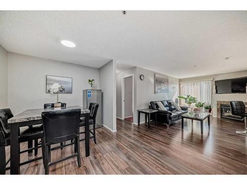 204-3204 Valleyview Park Se, Calgary, AB - Indoor Photo Showing Dining Room With Fireplace