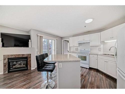 204-3204 Valleyview Park Se, Calgary, AB - Indoor Photo Showing Kitchen With Fireplace