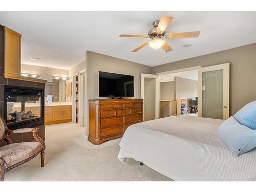 1118 Wentworth View Sw, Calgary, AB - Indoor Photo Showing Bedroom With Fireplace