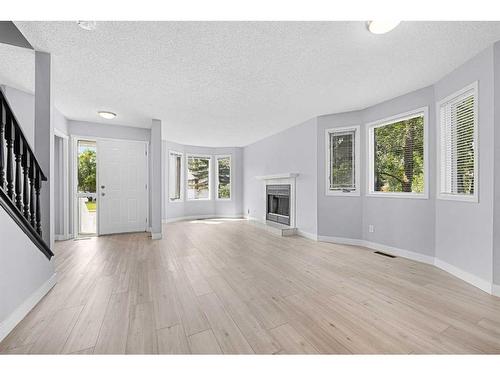 6 Abbeydale Villas Ne, Calgary, AB - Indoor Photo Showing Living Room With Fireplace