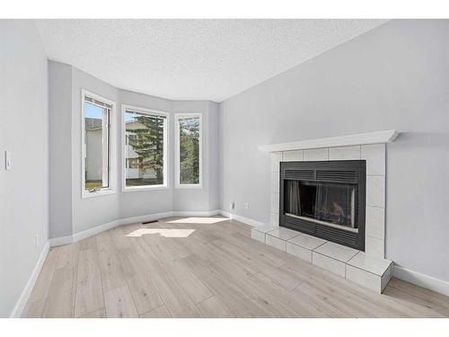 6 Abbeydale Villas Ne, Calgary, AB - Indoor Photo Showing Living Room With Fireplace