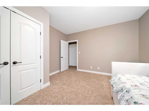 564 Harrison Court, Crossfield, AB - Indoor Photo Showing Bedroom