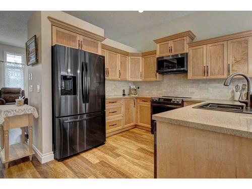 344 Willow Ridge Manor, Diamond Valley, AB - Indoor Photo Showing Kitchen With Stainless Steel Kitchen